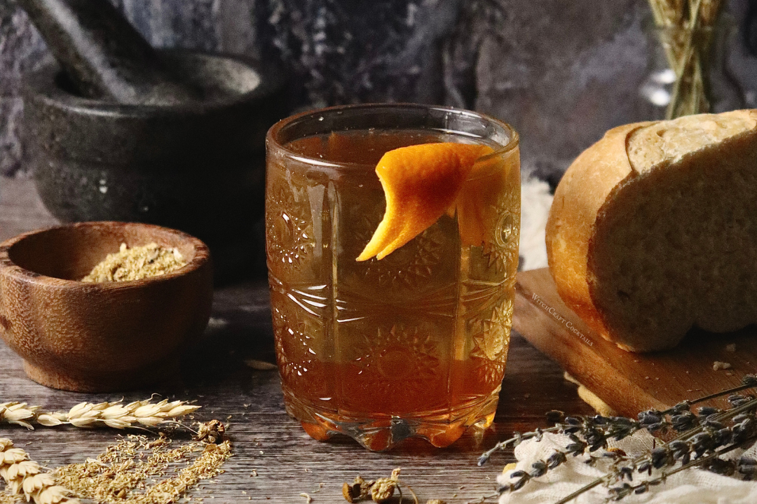 A honey old fashioned with an orange peel garnish.