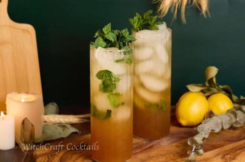 Fresh and vibrant herbal mojitos served in tall, elegant glasses with mint and lime, perfect for witchcraft-inspired cocktail recipes and magical gatherings.
