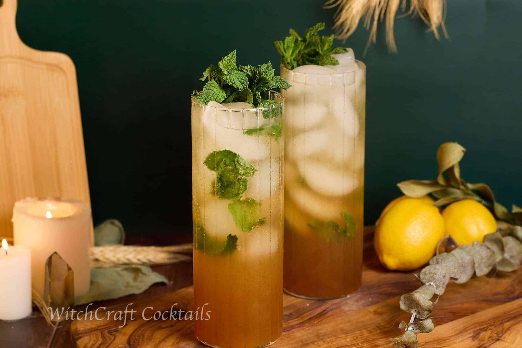 Fresh and vibrant herbal mojitos served in tall, elegant glasses with mint and lime, perfect for witchcraft-inspired cocktail recipes and magical gatherings.