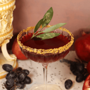 A Gladiator-inspired drink recipe with bay leaf and a gold sugar rim.