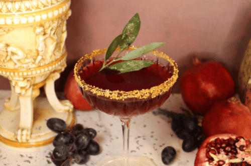 A Gladiator-inspired drink recipe with bay leaf and a gold sugar rim.